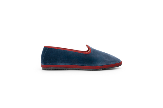 A denim and red velvet slipper shoe and flat sole.