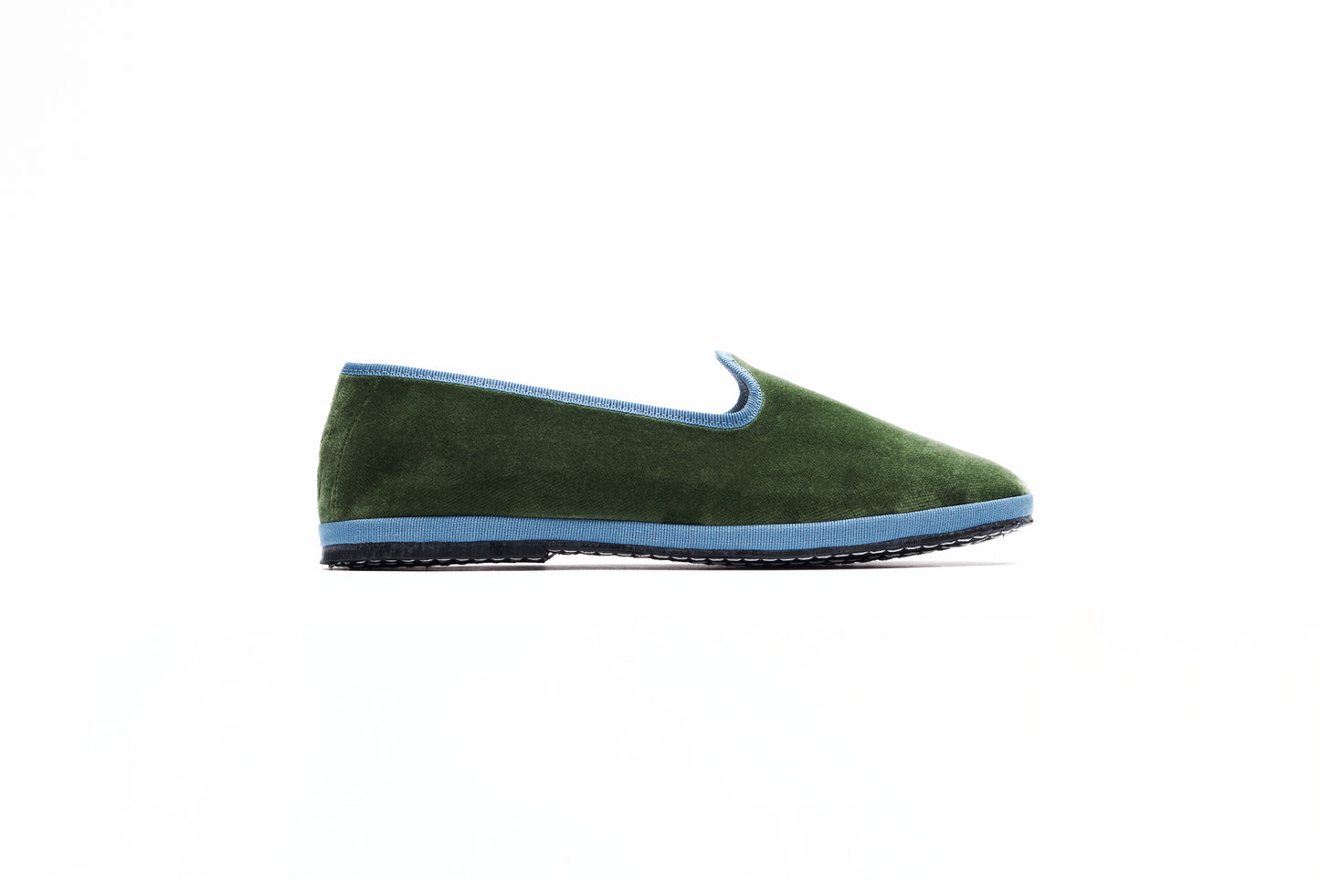 A military green velvet slipper featuring a blue accent and flat heel. Made in Italy. Artisanal product.