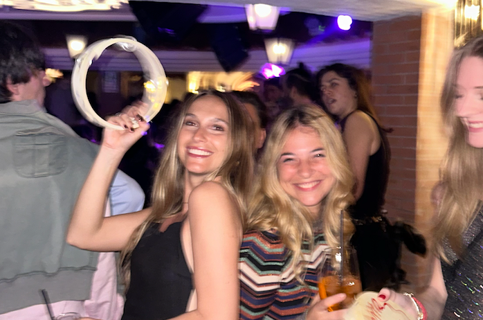 Exploring the Amalfi Coast with the Girls enjoying a lively night out, smiling and celebrating together.