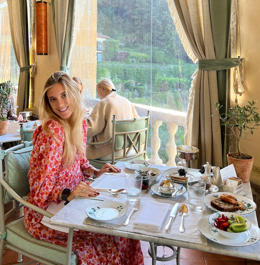 A woman enjoying breakfast at a beautiful restaurant during The Perfect Tuscan Getaway.