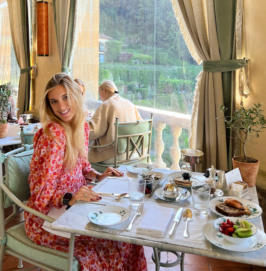 A woman enjoying breakfast at a beautiful restaurant during The Perfect Tuscan Getaway.
