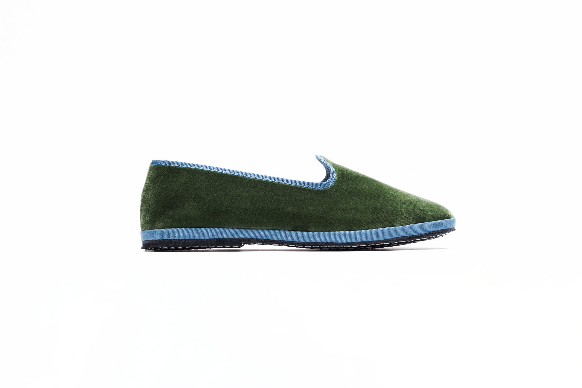 A military green velvet slipper featuring a blue accent and flat heel. Made in Italy. Artisanal product. 