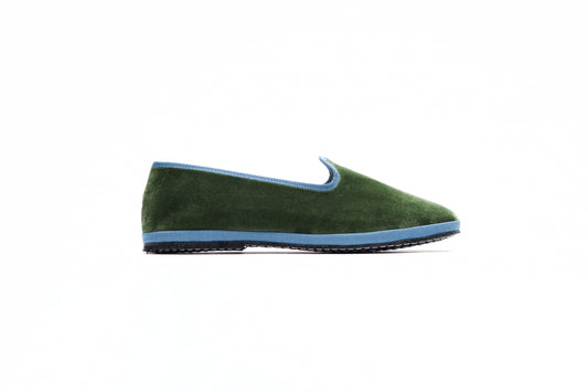 A military green velvet slipper featuring a blue accent and flat heel. Made in Italy. Artisanal product. 